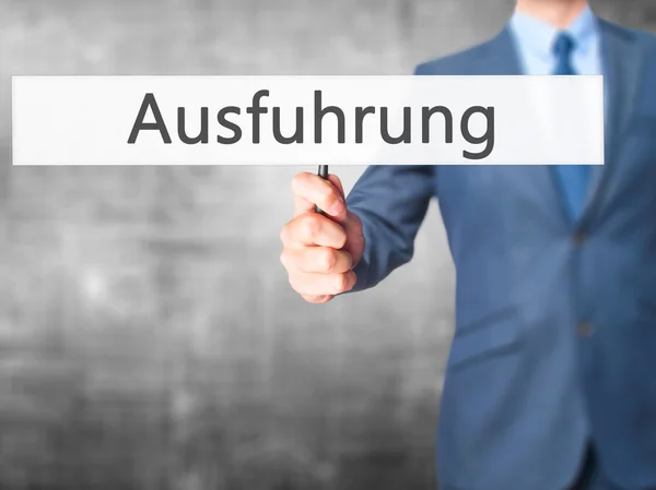 Ausfuhrung (avrättning på tyska)-Business man visar Sign — Stockfoto