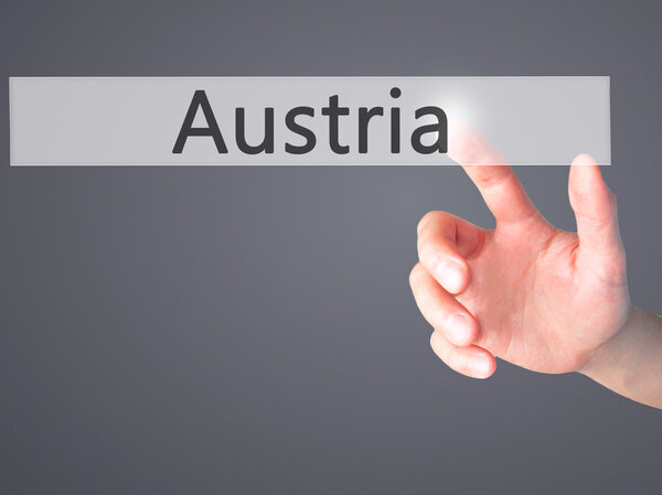 Austria - Hand pressing a button on blurred background concept o