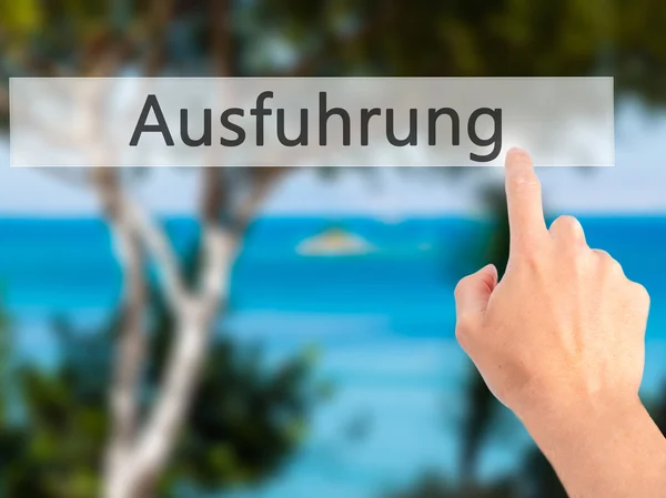 Ausfuhrung (ドイツ語で実行) - 手をブルーのボタンを押すと — ストック写真