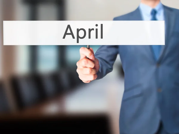 April - Business man showing sign — Stock Photo, Image