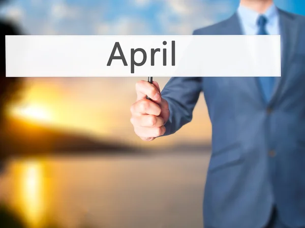 April - Business man showing sign — Stock Photo, Image