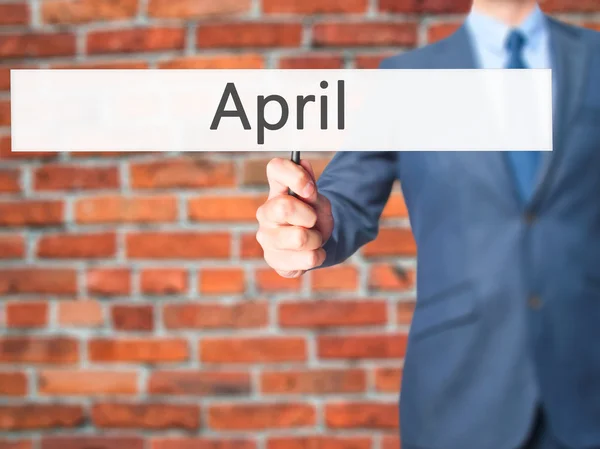 April - Business man showing sign — Stock Photo, Image