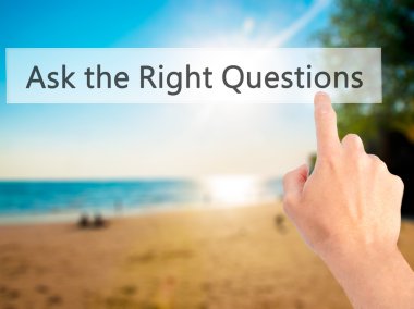 Ask the Right Questions - Hand pressing a button on blurred back clipart