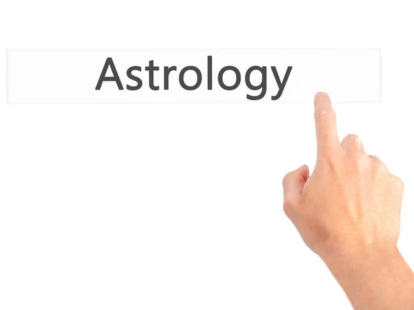 Astrologie - Hand indrukken van een knop op onscherpe achtergrond concept — Stockfoto