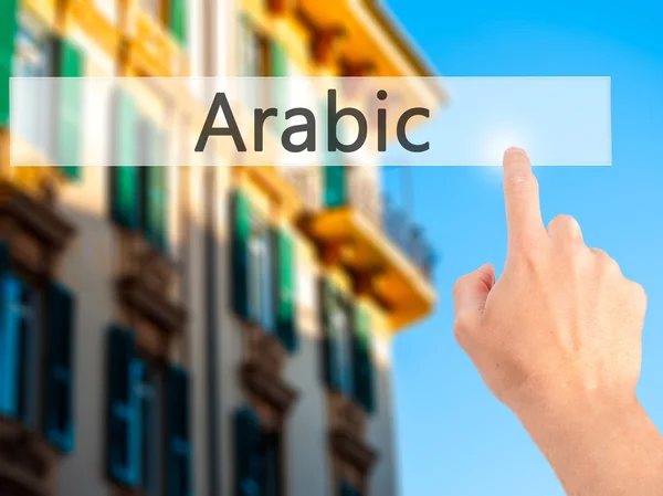 Arabisk - Håndtrykk på en knapp for uskarpt bakgrunnskonsept – stockfoto