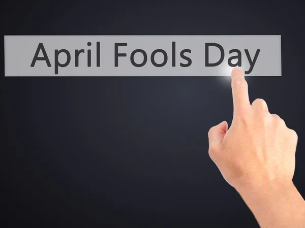 April Fools Day - Hand indrukken van een knop op de onscherpe achtergrond c — Stockfoto