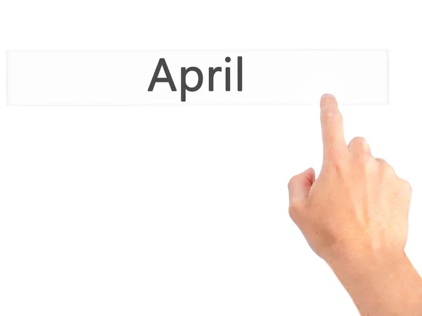 April - Hand pressing a button on blurred background concept on — Stock Photo, Image