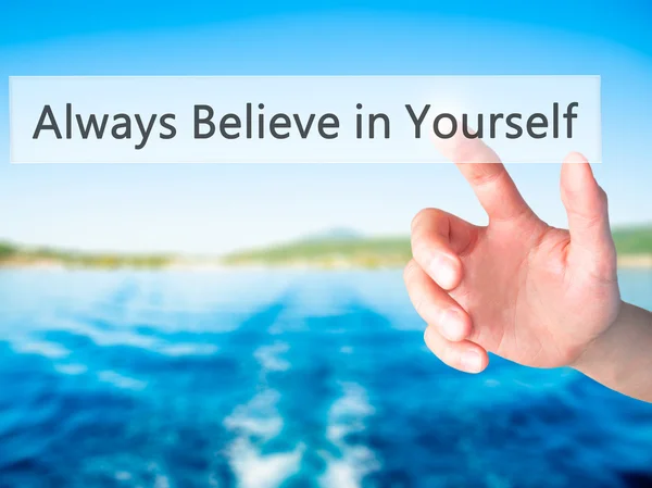 Always Believe in Yourself - Hand pressing a button on blurred b — Stock Photo, Image