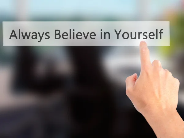 Always Believe in Yourself - Hand pressing a button on blurred b — Stock Photo, Image