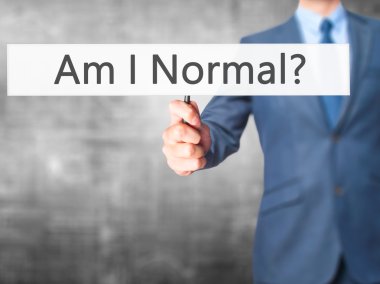 Normal miyim? -İş adamı el işareti tutarak