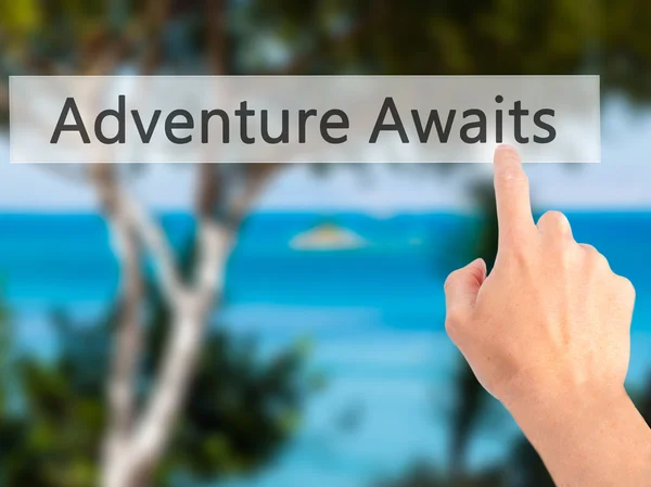 Abenteuer erwartet - Hand auf Knopfdruck auf verschwommenem Hintergrund — Stockfoto