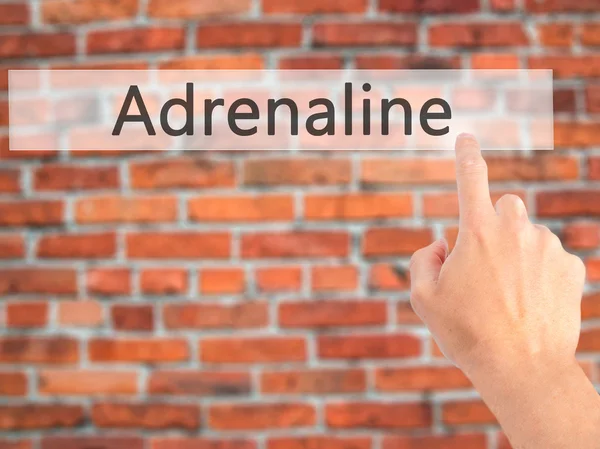 Adrenalina - Premere a mano un pulsante su sfondo sfocato concep — Foto Stock