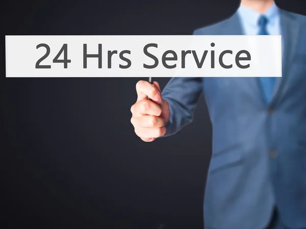 24 Hrs Service - Business man showing sign — Stock Photo, Image