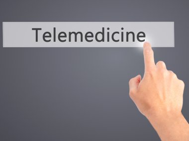 Telemedicine - Hand pressing a button on blurred background conc clipart
