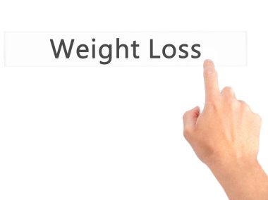 Kilo kaybı - arka plan bulanık conce üzerinde bir düğmeye basarak el