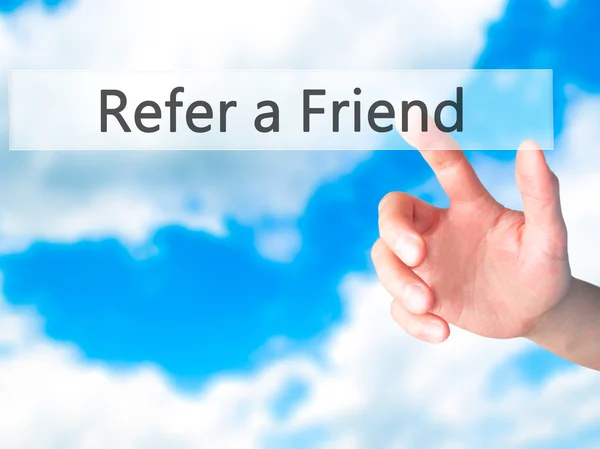 Refer a Friend - Hand pressing a button on blurred background co — Stock Photo, Image