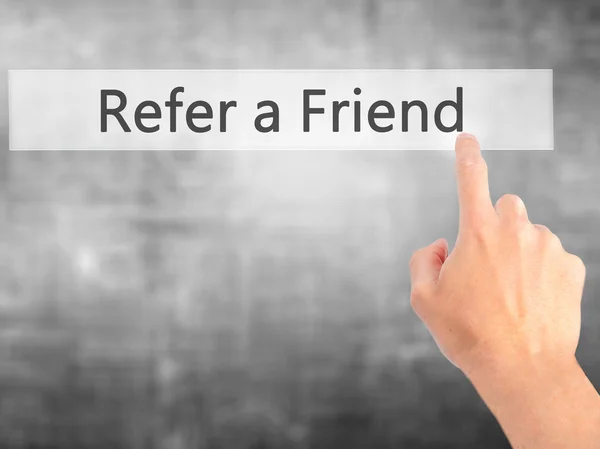 Refer a Friend - Hand pressing a button on blurred background co — Stock Photo, Image