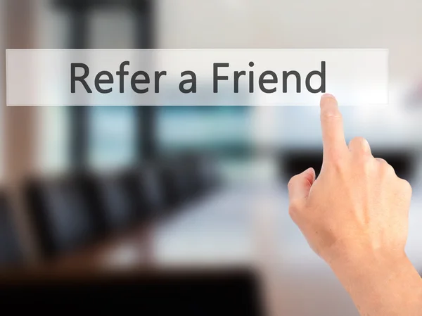 Refer a Friend - Hand pressing a button on blurred background co — Stock Photo, Image