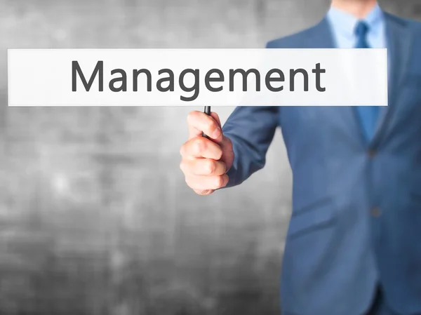 Management - Business man showing sign — Stock Photo, Image