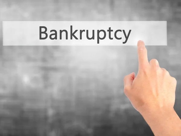 Bankruptcy - Hand pressing a button on blurred background concep — Stock Photo, Image