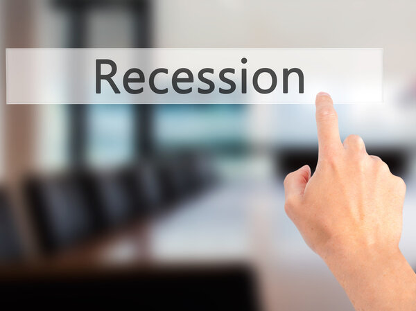 Recession - Hand pressing a button on blurred background concept