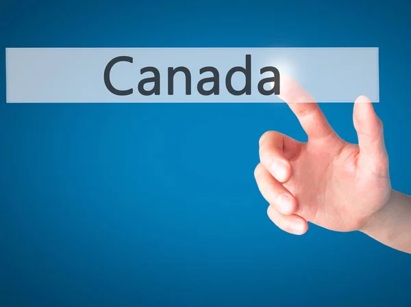 Καναδάς - χέρι πατώντας ένα κουμπί στην έννοια θολή φόντο — Φωτογραφία Αρχείου