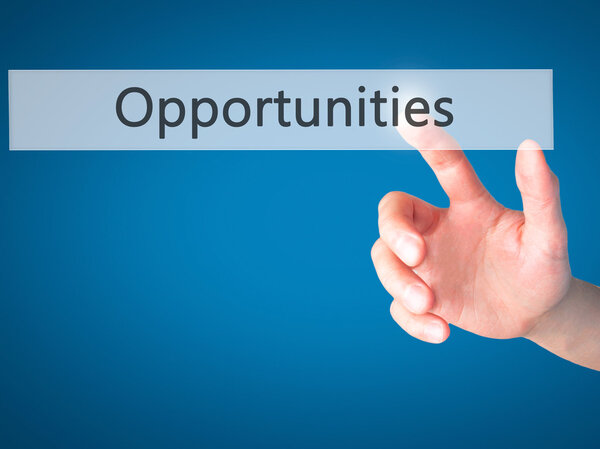 Opportunities - Hand pressing a button on blurred background con