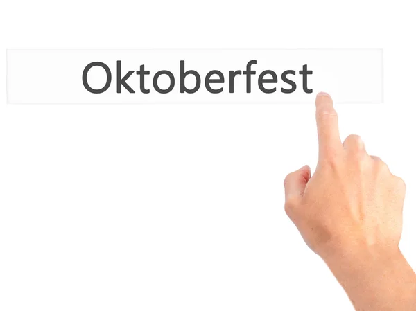 Oktoberfest - Hand pressing a button on blurred background conce — Stock Photo, Image