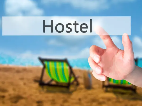 Hostel - Hand pressing a button on blurred background concept on — Stock Photo, Image