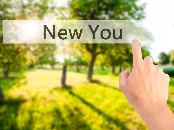 New You - Hand pressing a button on blurred background concept o — Stock Photo, Image