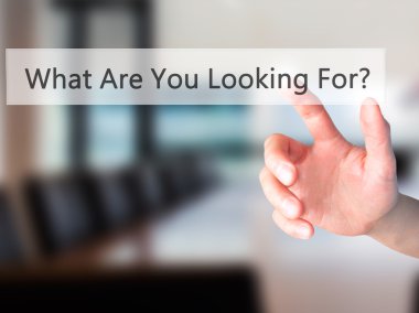 What Are You Looking For ? - Hand pressing a button on blurred b