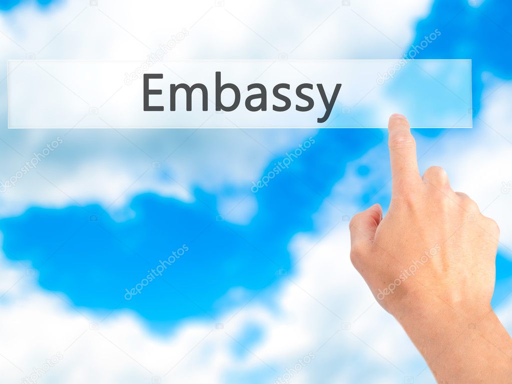 Embassy - Hand pressing a button on blurred background concept o