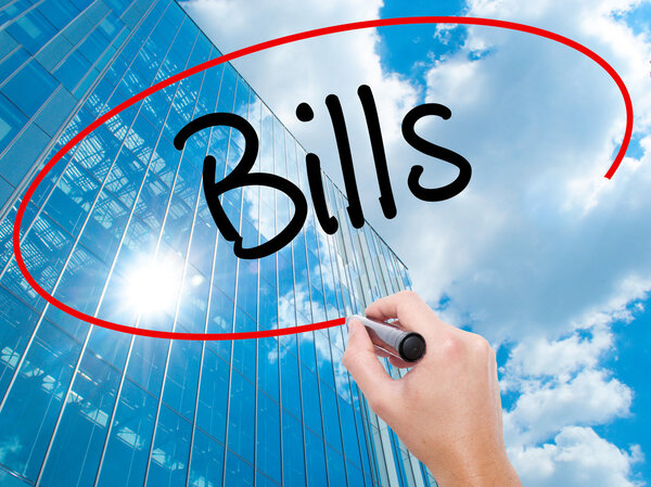 Man Hand writing Bills with black marker on visual screen