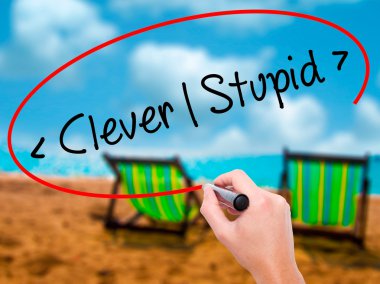 Man Hand writing Clever - Stupid with black marker on visual scr clipart