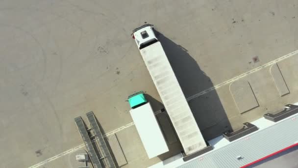 Letecký pohled na návěsy s nákladními automobily stojící u skladových ramp pro nakládku / vykládku zboží v logistickém parku — Stock video