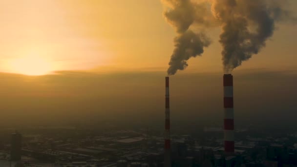 Power Plant emissions seen above the city  during sunrise. Environmental pollution. Factory pipe polluting air.Panorama sunset. Smoking pipes Aerial view, — Stock Video