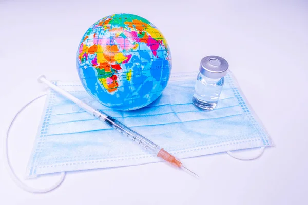 Medical drug vaccine syringe needle hypodermic injection treatment on map world ,Medical concept tourism travel care diseases Healthy .Covid 19, Flue shot. selective focus