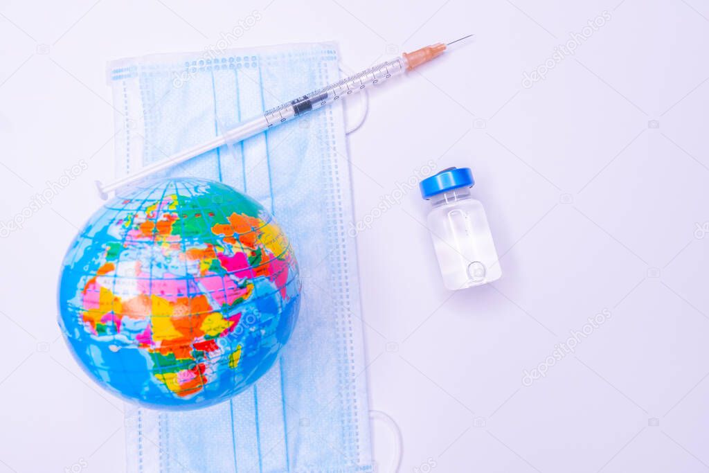 Medical drug vaccine syringe needle hypodermic injection treatment on map world ,Medical concept tourism travel care diseases Healthy .Covid 19, Flue shot. selective focus