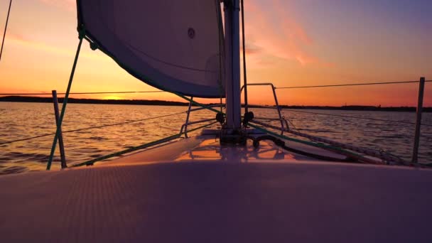 A cinematic scene of  small sailing yacht boats sailing along the golden calm waters on lake, river, sea or ocean. Beautiful sunset or sunrise, relaxation, calmness, sailing, sailors. Luxury living — Stock Video