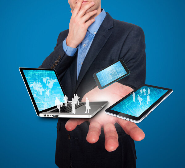 Businessman holds modern technology in hands - Stock Image