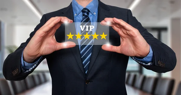 Businessman holds vip five stars in his hands- Stock Image — Stock Photo, Image