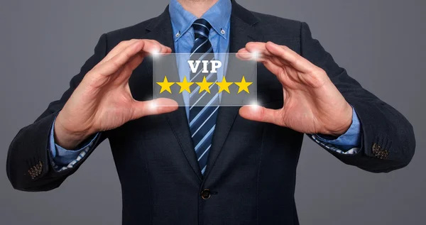 Businessman holds vip five stars in his hands- Stock Image — Stock Photo, Image