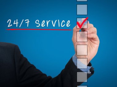Businessman Checking 24h Service. Checking mark on checklist marker. Isolated on blue background, Stock Photo