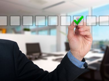 Businessman ticks off in in a square. Task list concept. Isolated on grey background.