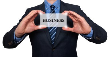 Businessman holds white card with Business sign. Isolated on various backgrounds ( grey, blue, office, white) - Stock Image