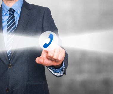 Businessman pressing phone button on visual screen. Customer support concept.  Stock Image