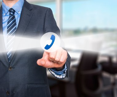 Businessman pressing phone button on visual screen. Customer support concept.  Stock Image