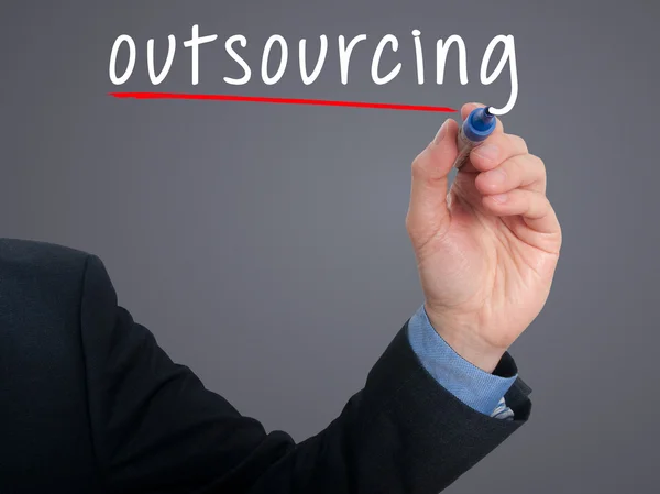 Businessman hand writing Outsourcing. Business concept.Stock Photo — Stock fotografie