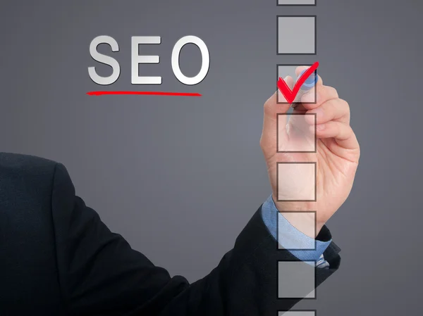 Businessman checking mark on SEO checklist marker. Checking SEO. Isolated on  background, Stock Photo — Stock Photo, Image