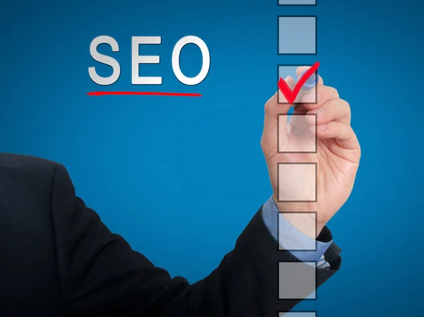 Businessman checking mark on SEO checklist marker. Checking SEO. Isolated on  background, Stock Photo
